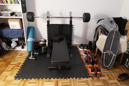 Small but all mine: home gym featuring bench and a few dumbbells for strength training.