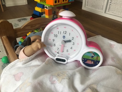 La sveglia per bambini è composta di un orologio analogico ben fatto, un orologio digitale troppo piccolo e l'indicazione se è ora di dormire o di giocare.