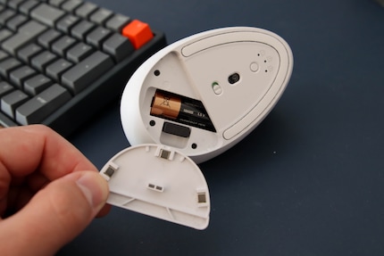 View of the bottom with inserted battery and stored USB dongle for Logi Bolt
