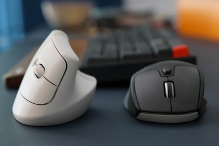 Rubbing shoulders: the vertical Logitech Lift and the classic M720