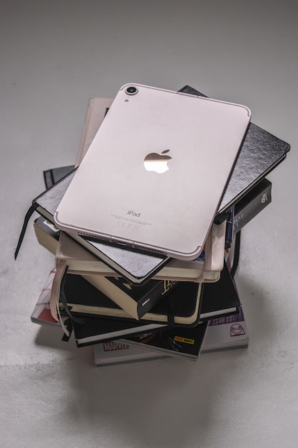 The iPad Mini hardly looks out of place in my pile of notebooks.