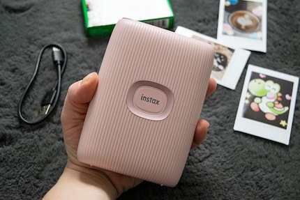 The Instax fits well in my hand and has a big power button on the front.