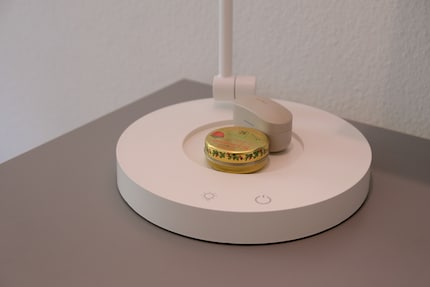 On the base of the lamp, there's room for a drink or headphones. Handy!