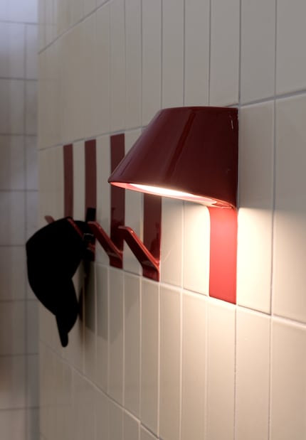 Qui non solo le piastrelle vengono portate a parete, ma anche lampade e ganci in ceramica.