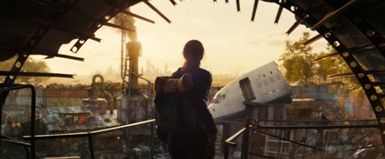 Lucy enters a settlement in post-apocalyptic Los Angeles. It's been put together from pieces of scrap metal lying around. No comparison to Lucy's high-tech vault.