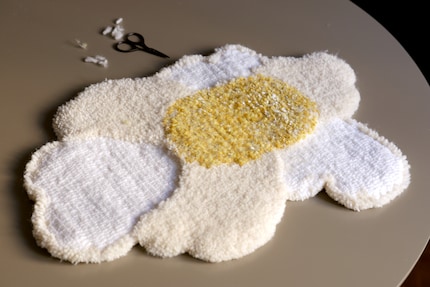 Once the rug is detached from the frame, it can be cut to size.