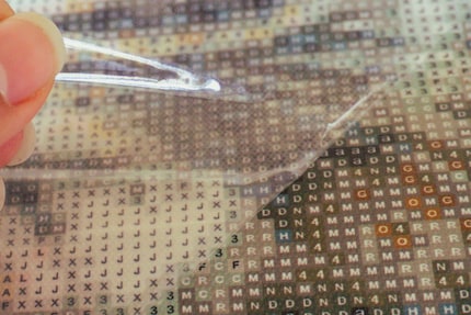 The canvas is provided with an adhesive layer the diamonds stick to.