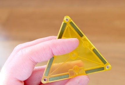 The transparent plastic provides a view of the magnetic blocks in individual tiles.