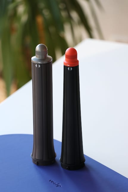 The cylindrical curler attachment on the left, the latest version on the right.