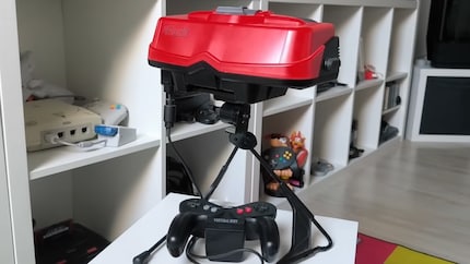 Il Virtual Boy con supporto e controller.