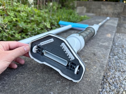Small brushes and wheels at the bottom of the suction head are designed to make the job easier.