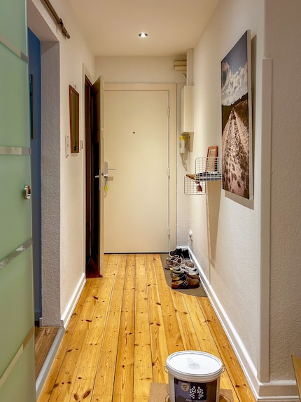The hallway before: all the walls are white.
